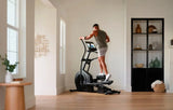 A person doing smart workout using iFit technology of NordicTrack Airglide 14i Elliptical Crosstrainer